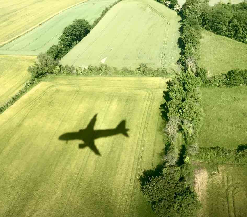 Plane flying over agricultural fields